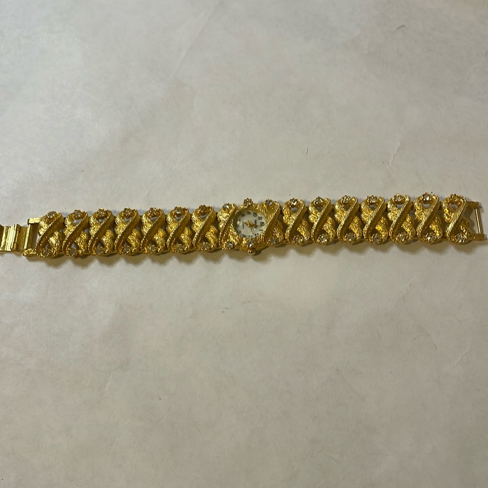 Infinity: Ladies goldtone quartz watch with RHINESTONES (vintage)